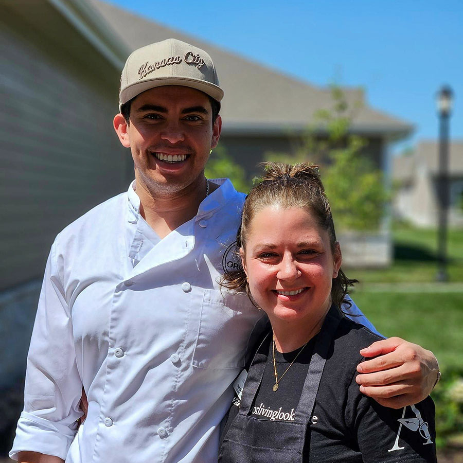 The talented chefs Kristen and Jason are smiling together after cooking a fantastic barbecue for Memorial Day.