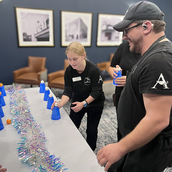 Team members smile and concentrate as they play a game during a team event.